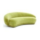 Julep Sofa with rounded backrest, sculptural curves, and soft fabric upholstery in modern minimalist style.