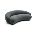 Julep Sofa with rounded backrest, sculptural curves, and soft fabric upholstery in modern minimalist style.