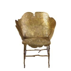 Luxury brass chair with tree-ring pattern and branch-like base