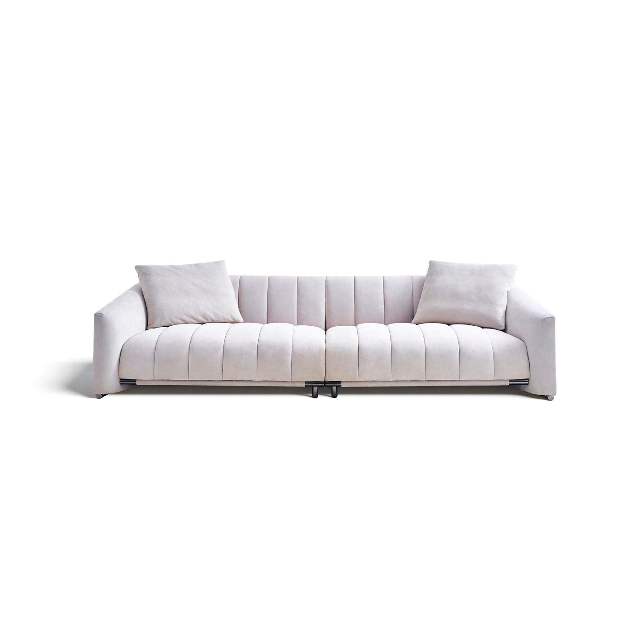 Beige frosted leather sofa with piano-key inspired cushions and stainless steel legs