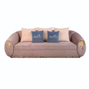 Sunlit Sofa with gold sculpted base and curved velvet upholstered body