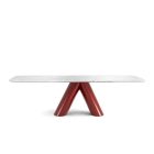 Viva Dining Table with red V-shaped pedestal and white marble top in modern minimalist style.