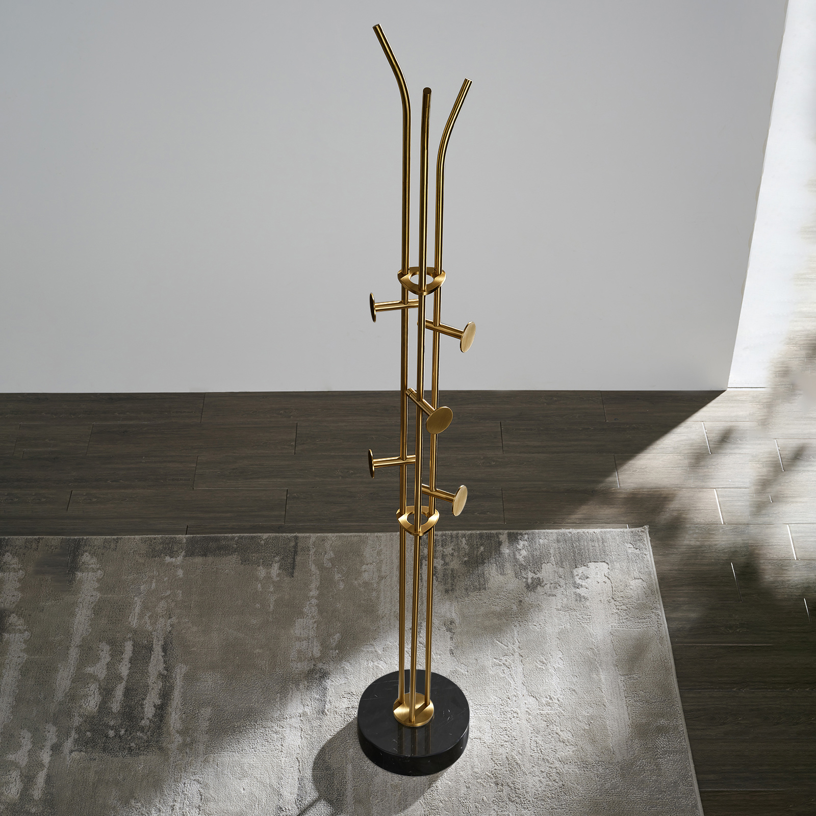 Stainless steel coat rack stand with black marble base and brushed gold-tone adjustable hooks