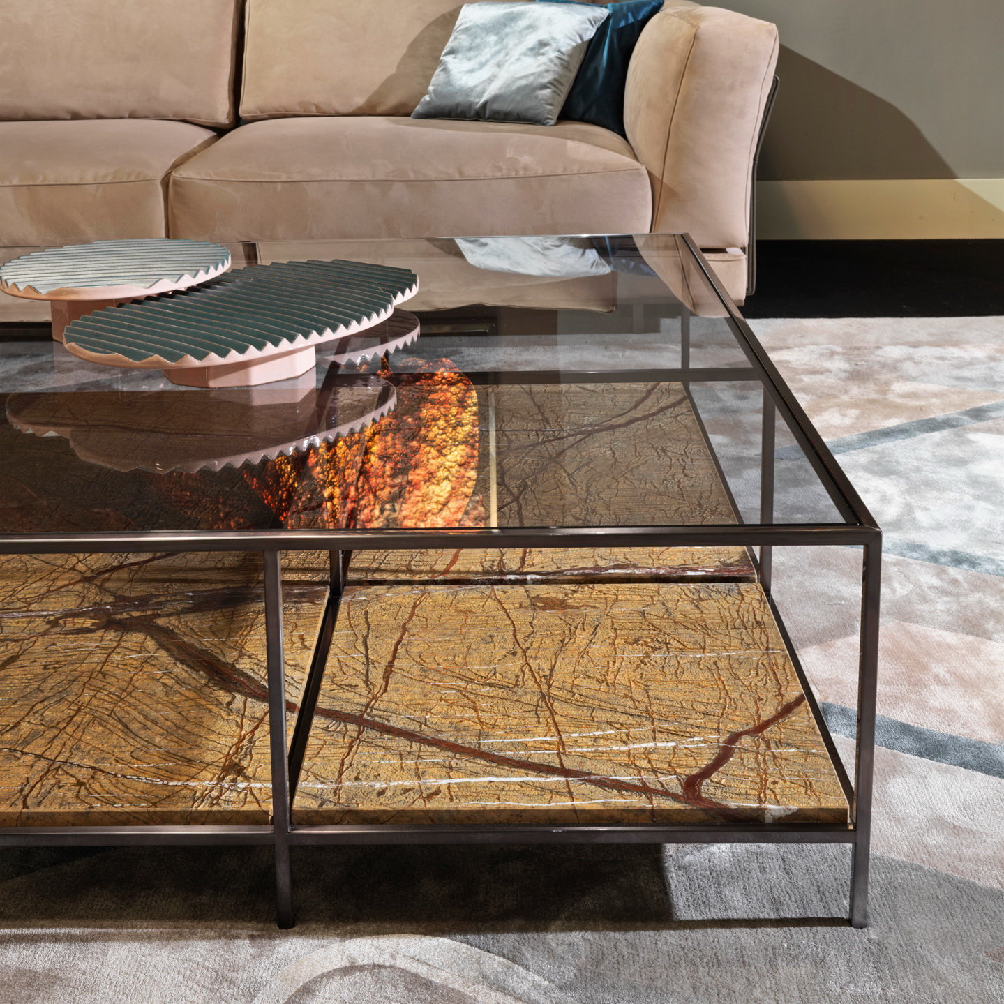 Dual-tier coffee table with extra-clear glass top and geometric natural marble lower shelf.
