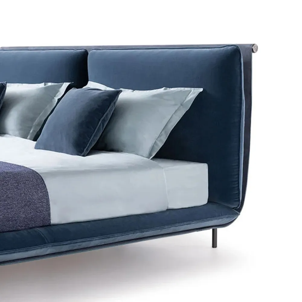 Contemporary fabric upholstered bed frame with polished stainless steel tapered legs.