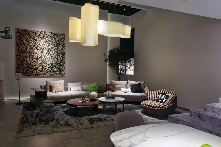 Modern Italian-inspired living room with low-profile sofas, sculptural lighting, and marble tables